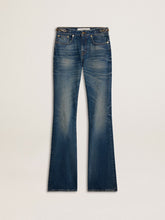 Women's bootcut jeans with a vintage wash and metallic details