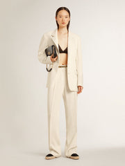 Women's loose pants in worn-white tailored fabric