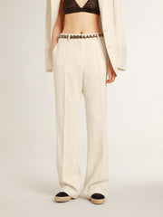 Women's loose pants in worn-white tailored fabric