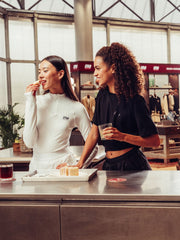 Women's white long-sleeve sports top with zip