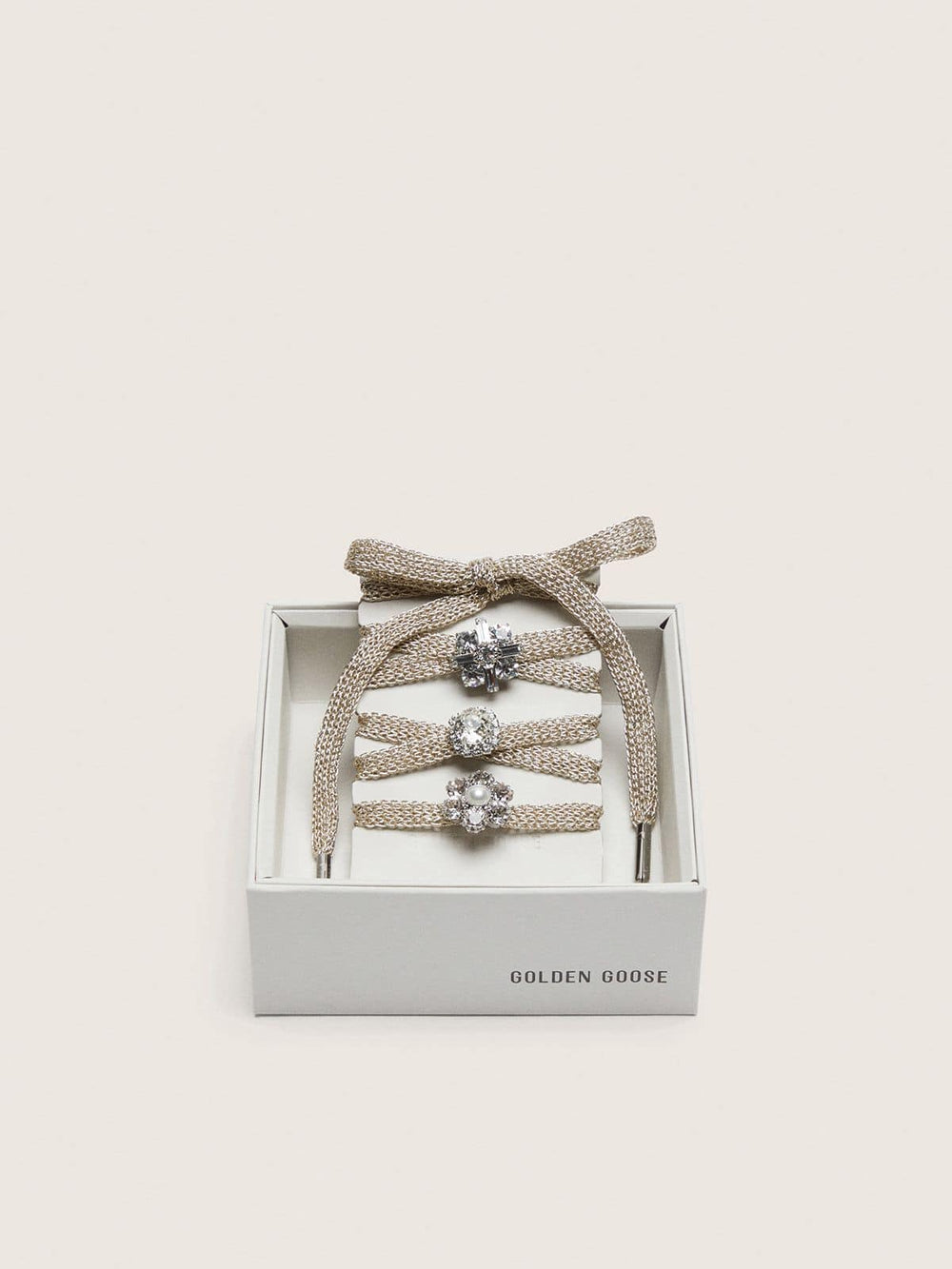 Skins braided gold-colored laces with shimmering charms