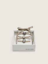 Skins braided gold-colored laces with shimmering charms