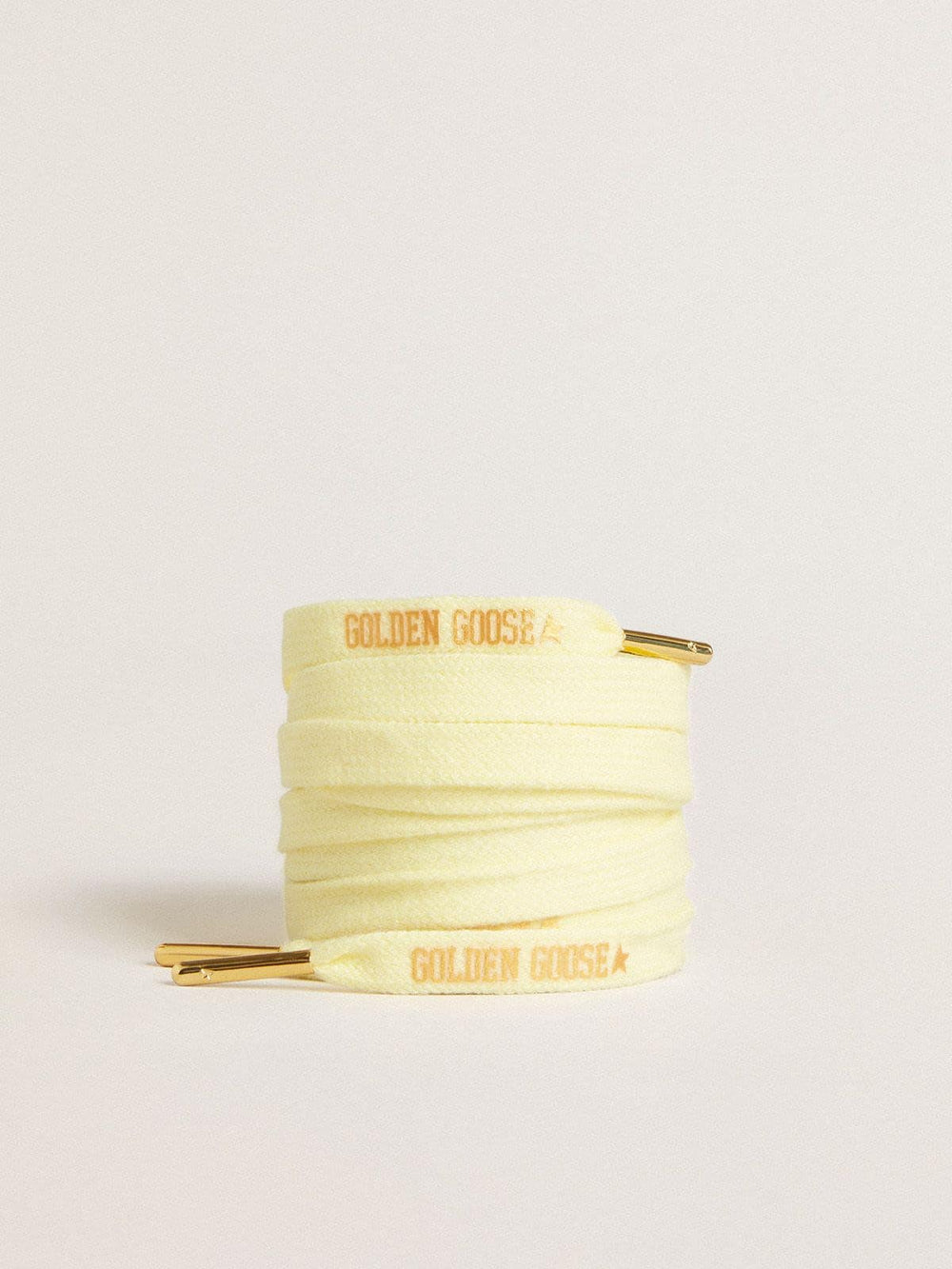 Yellow cotton laces with contrasting gold-colored logo