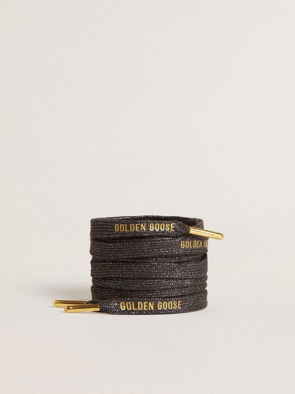 Dark gray lurex laces with contrasting gold logo