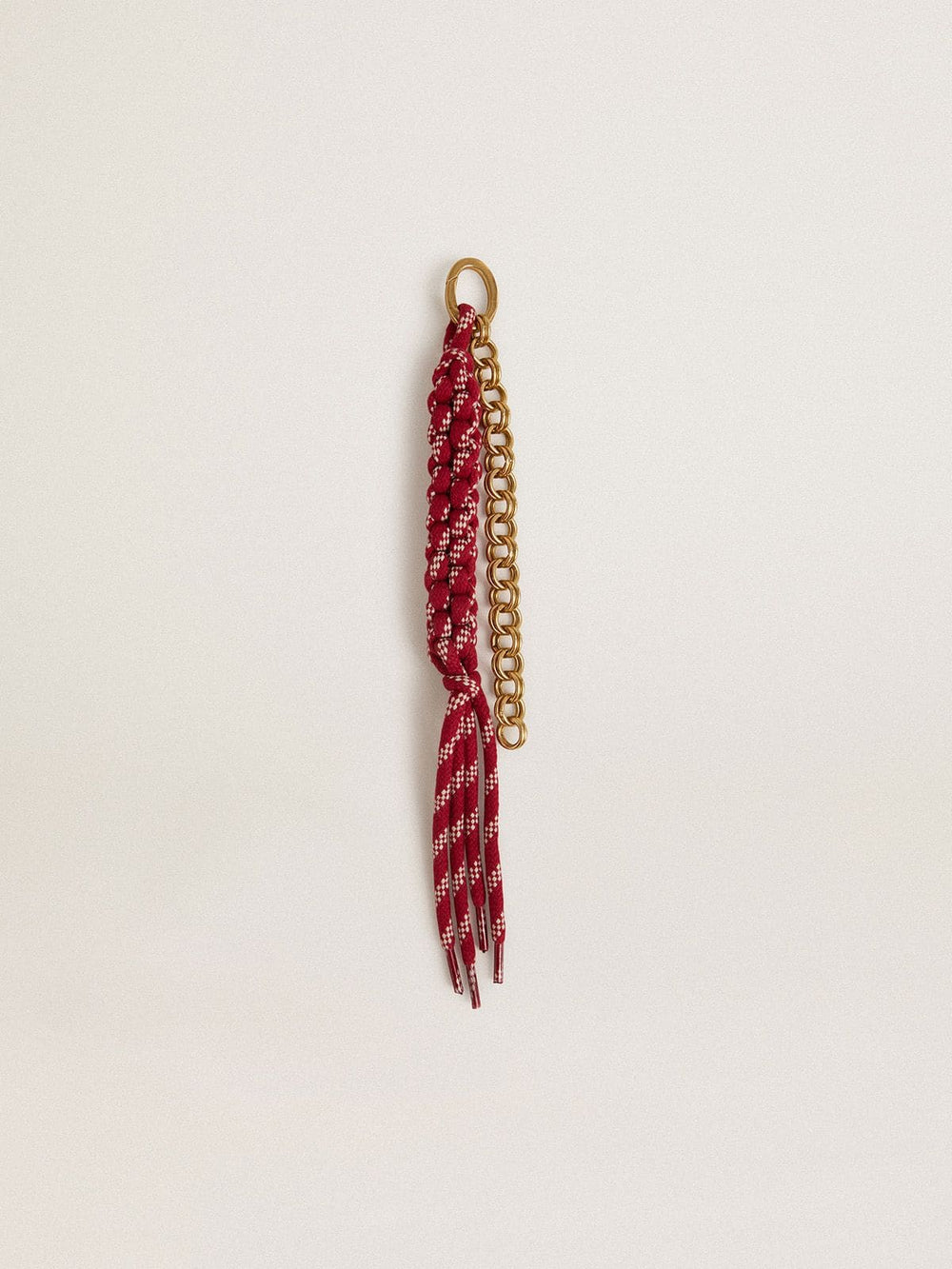 Charm with red knotted laces