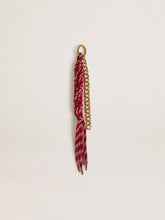 Charm with red knotted laces