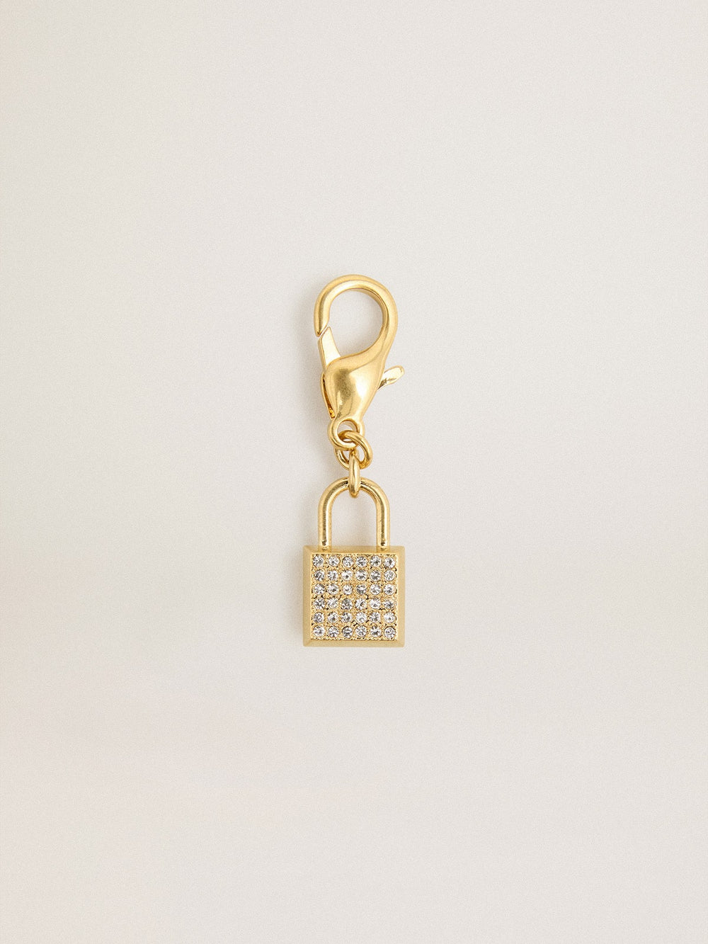 Lock-shaped charm in gold-colored brass with crystals