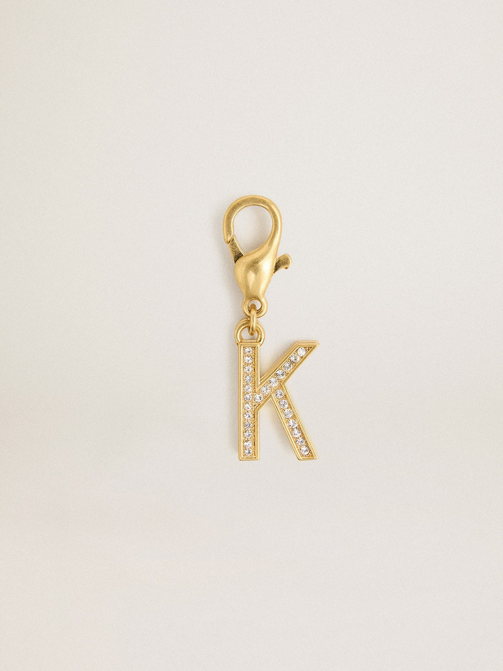 Letter K charm in gold-colored brass with crystals