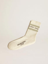 Worn-white socks with distressed details and sage-green stripes
