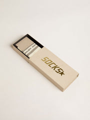 Worn-white socks with distressed details and sage-green stripes