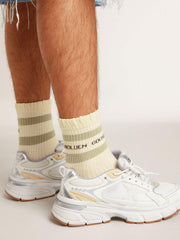 Worn-white socks with distressed details and sage-green stripes