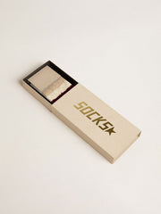 Worn-white socks with distressed details and beige and burgundy stripes