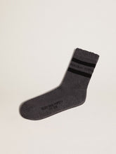 Grey socks with distressed details and black stripes