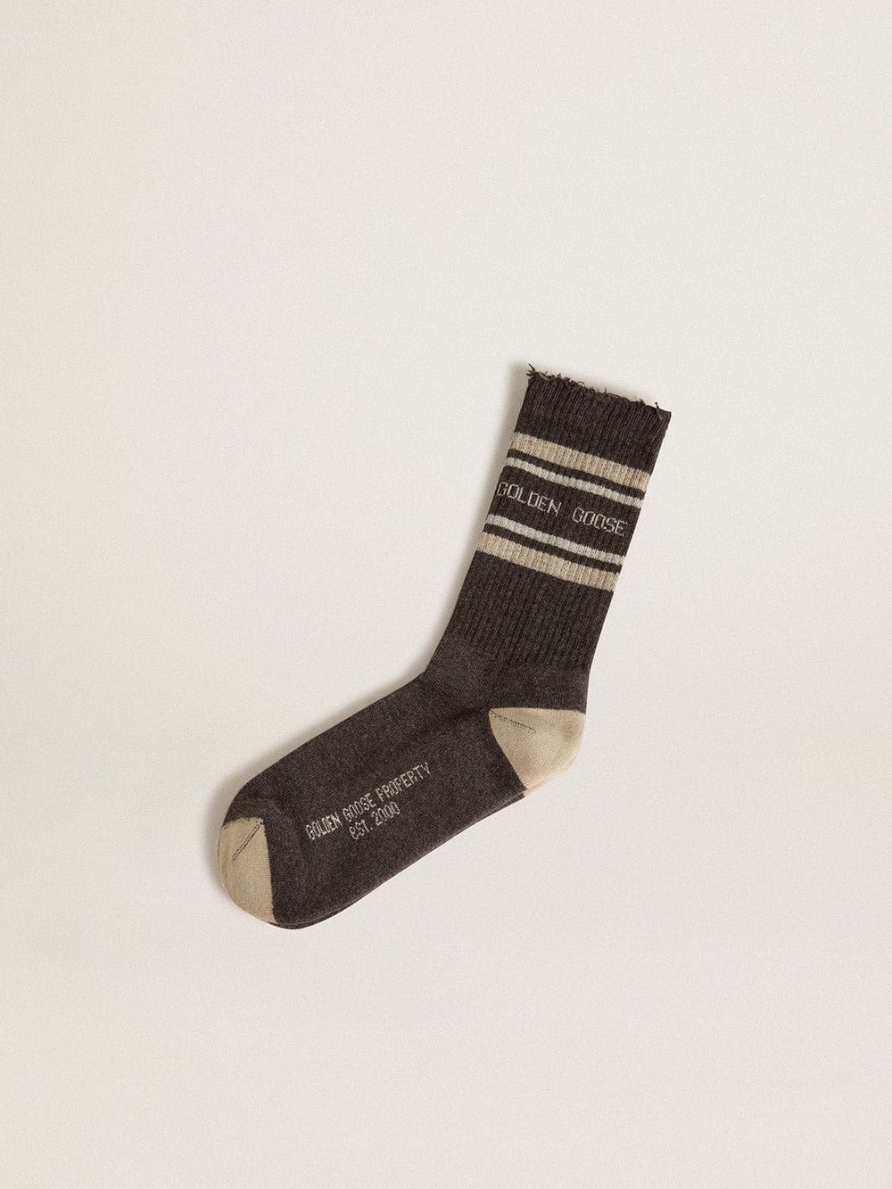 Dark grey socks with distressed details and cream and worn-white stripes