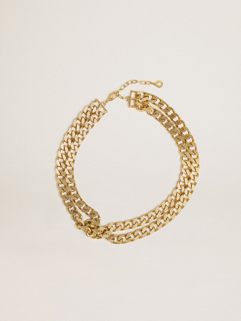 Antique gold-colored braided chain necklace with star-shaped clasp