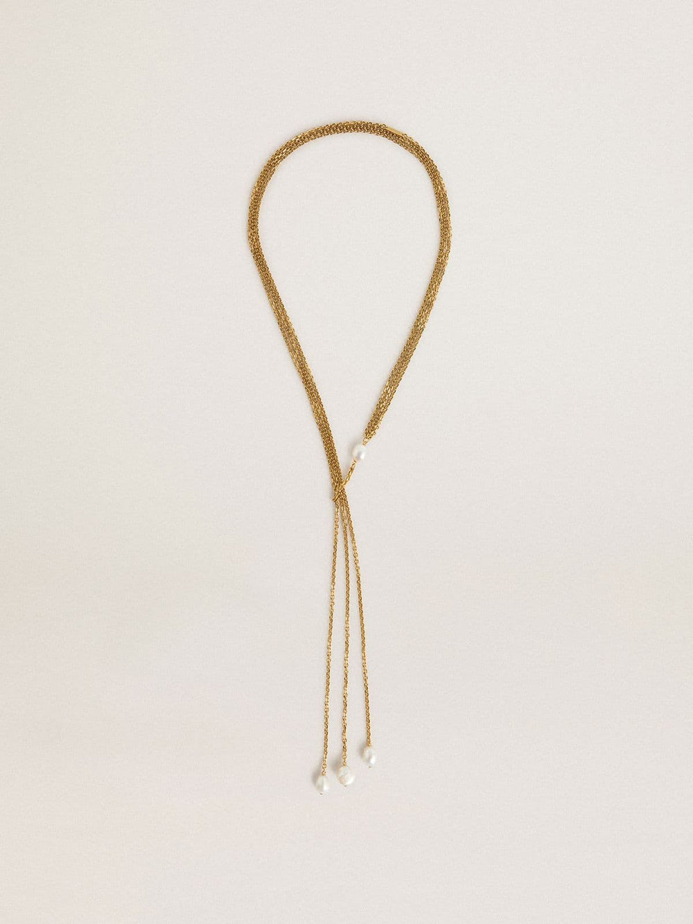 Necklace with antique gold-colored chains with pearls