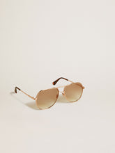 Aviator style sunglasses with rose-gold frame and honey-colored lenses
