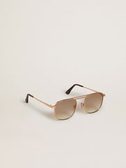 Aviator-style sunglasses with gold frame and beige lenses