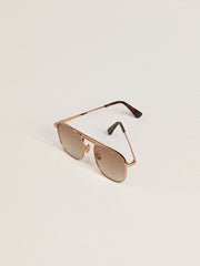 Aviator-style sunglasses with gold frame and beige lenses