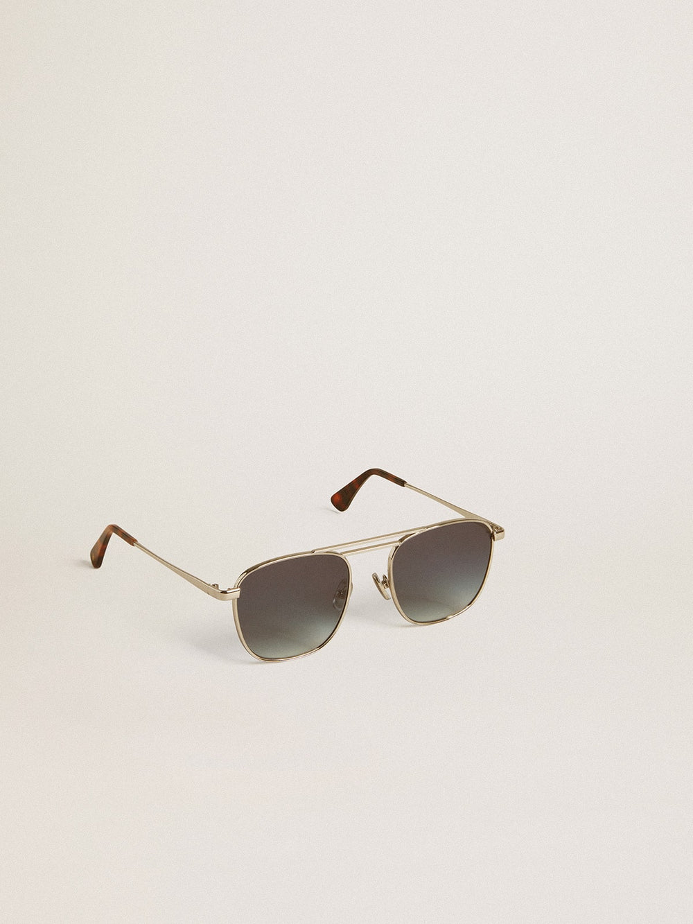 Aviator style sunglasses with silver frame and blue lenses