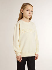 Girls’ cream-colored sweatshirt with patch writing