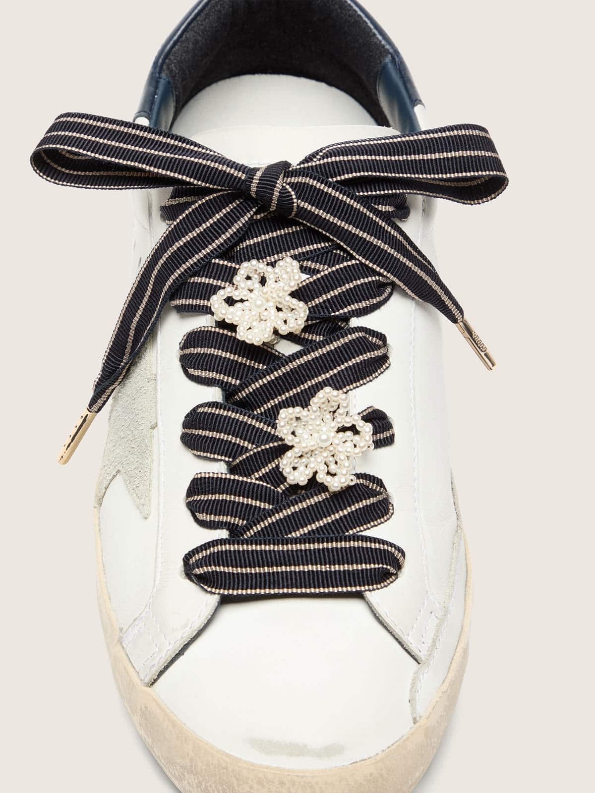 Skins white and dark blue striped laces with beaded charms