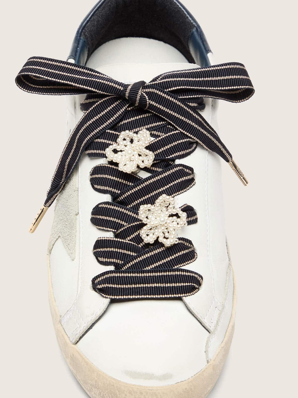 Skins white and dark blue striped laces with beaded charms