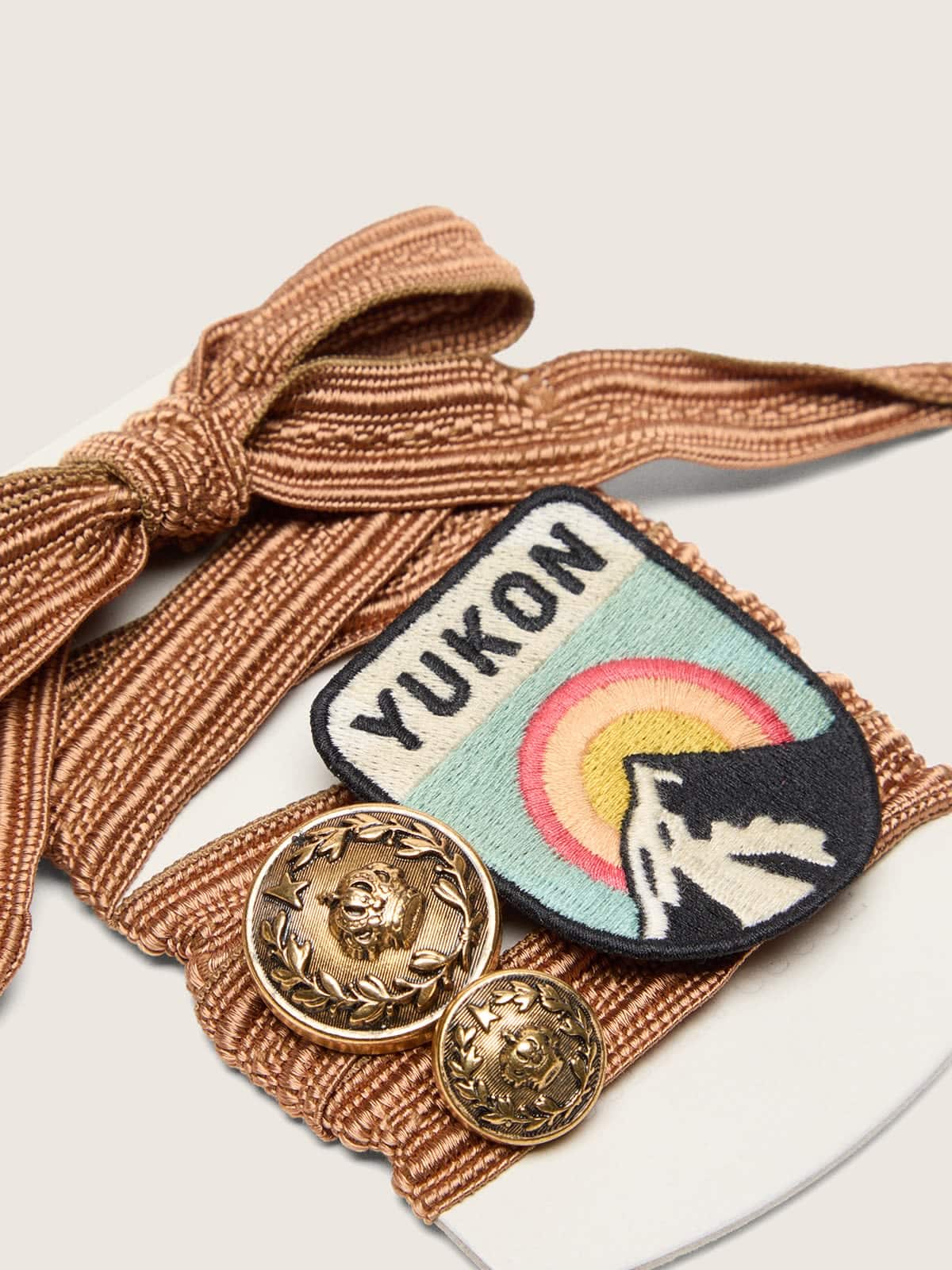 Skins burgundy and peach embroidered laces with patch and two charms