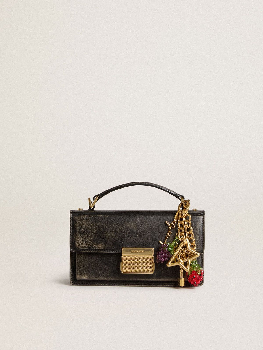 Gold-colored brass charm with Golden Goose signature