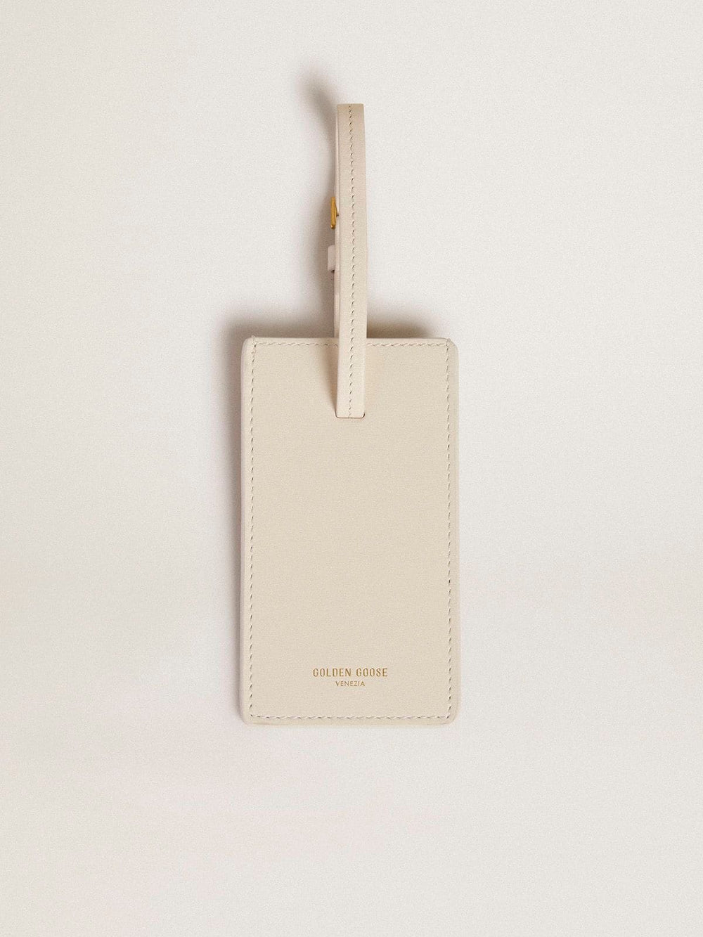 Worn white luggage tag