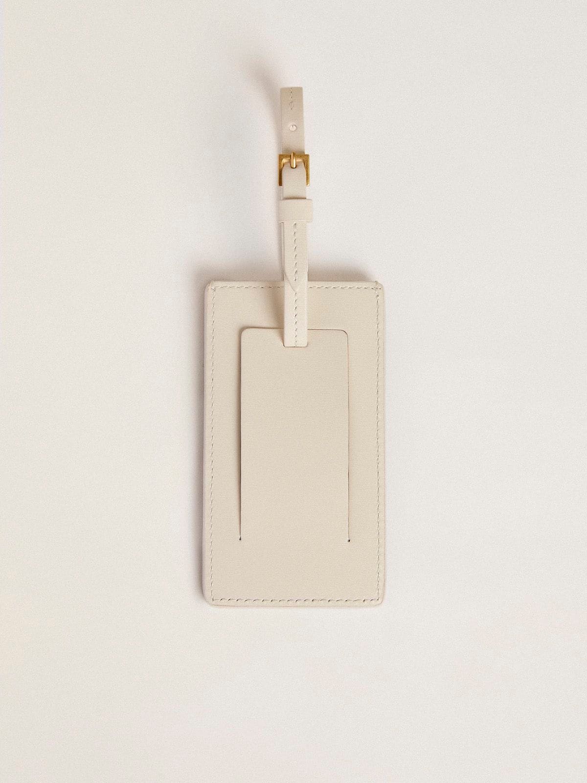 Worn white luggage tag