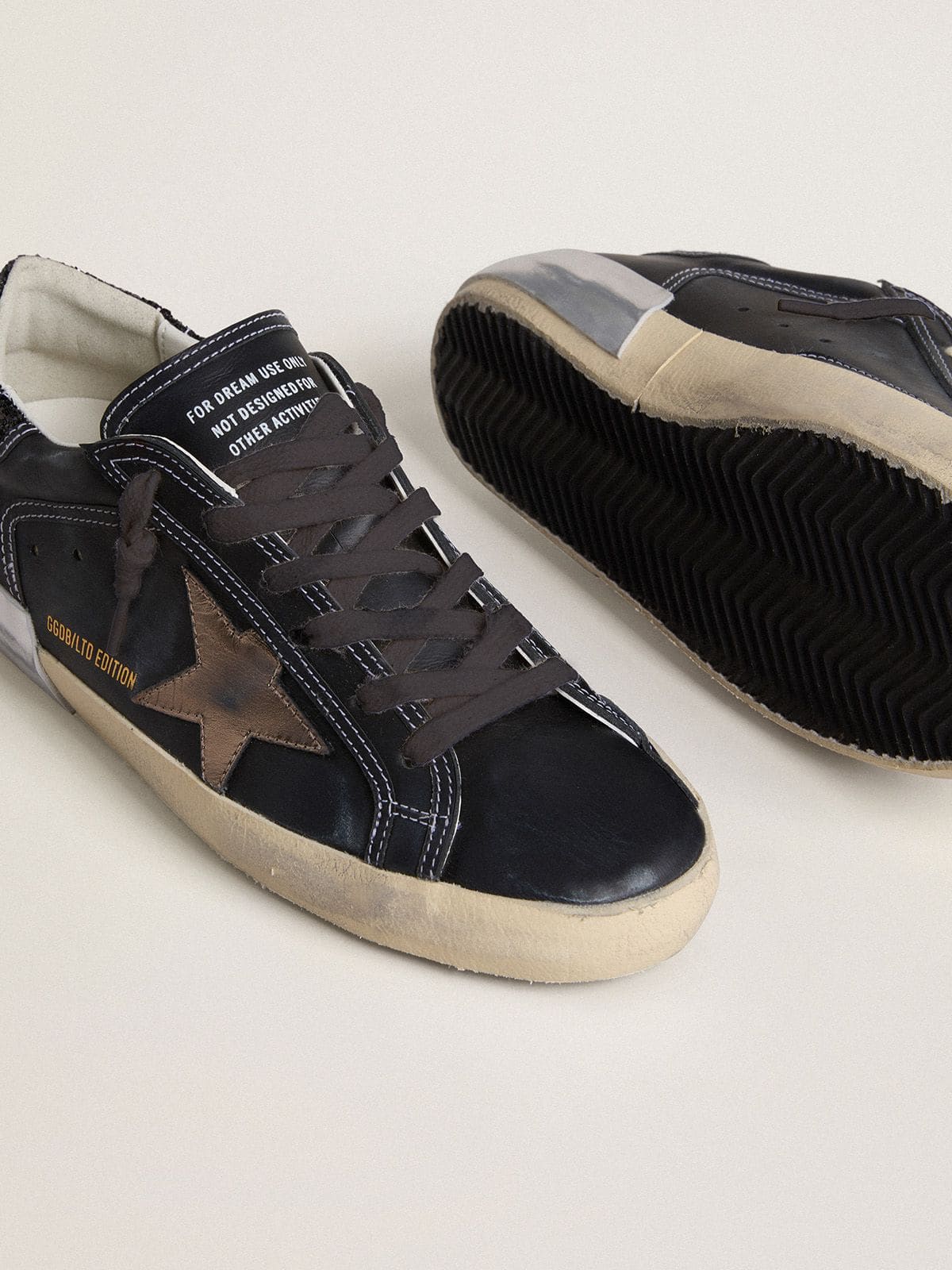 Women's Super-Star LTD in black leather with gold leather star and black glitter heel tab