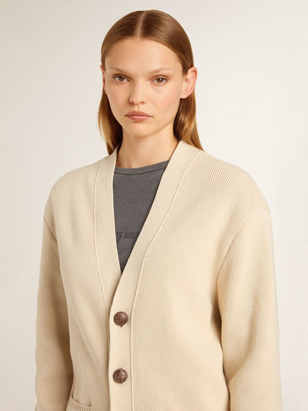 Women’s beige cardigan with 'Golden' lettering on the back