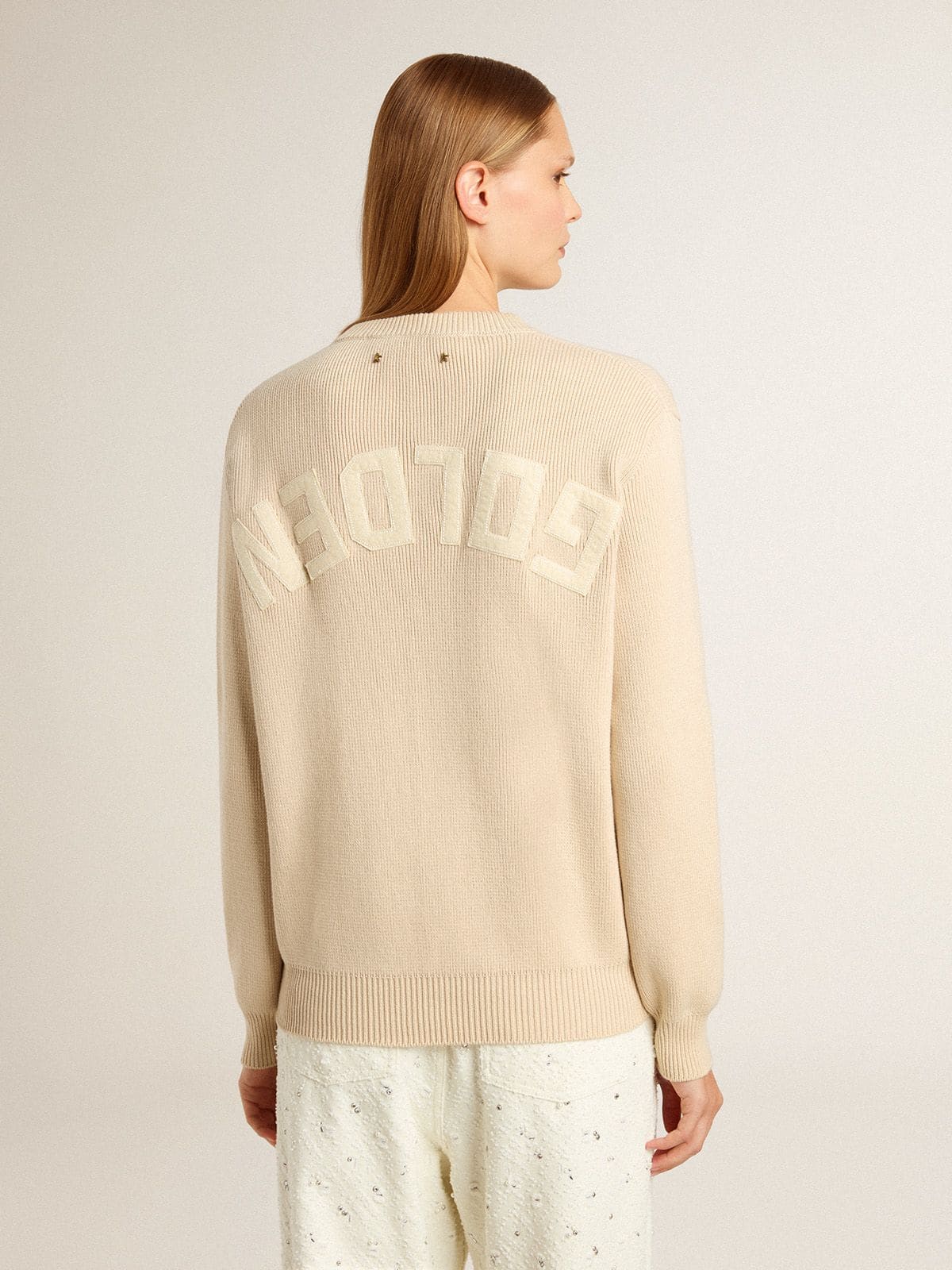 Women's beige sweater with 'Golden' lettering on the back
