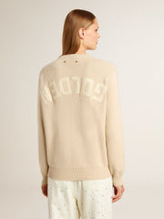 Women's beige sweater with 'Golden' lettering on the back