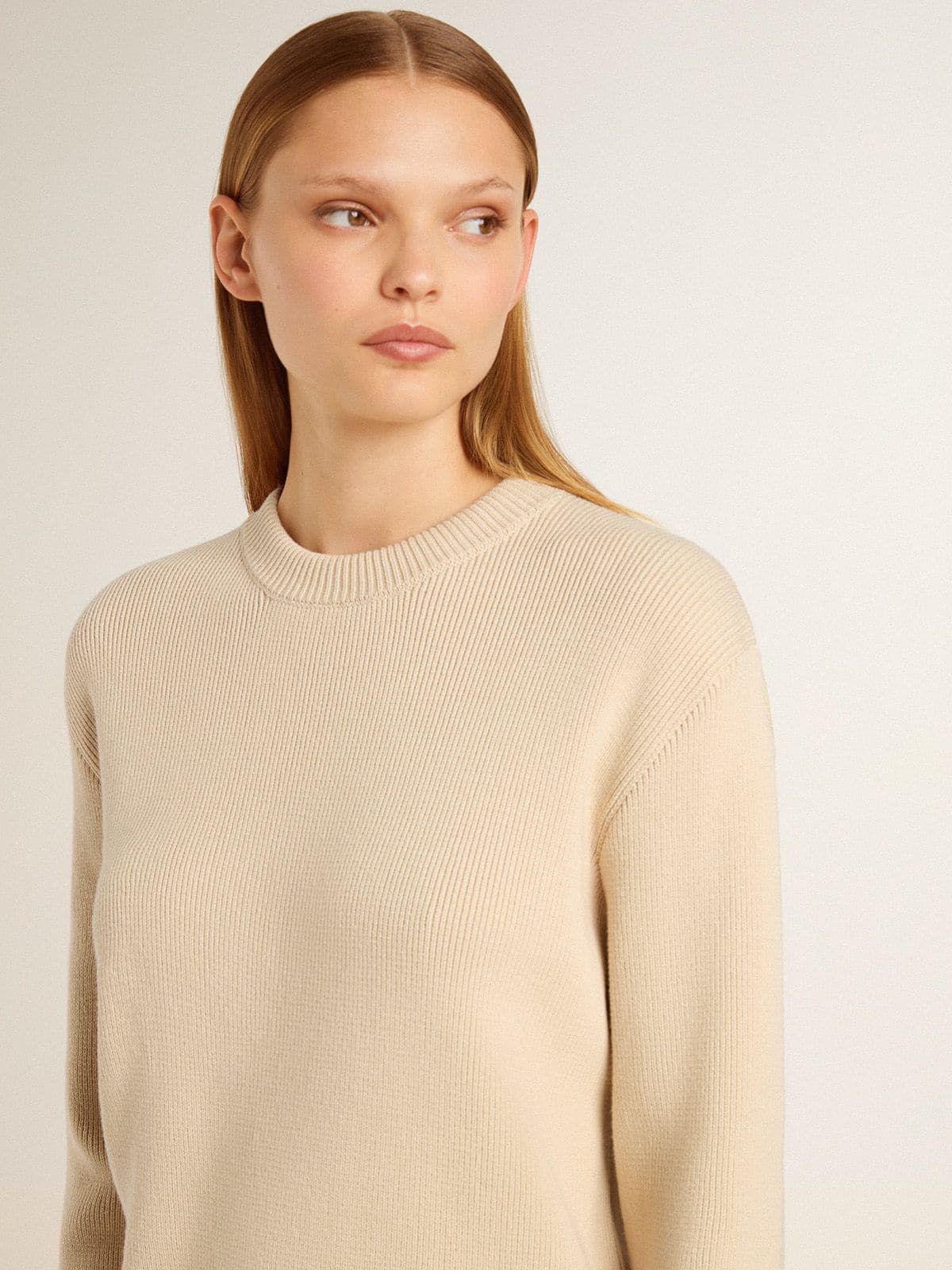 Women's beige sweater with 'Golden' lettering on the back