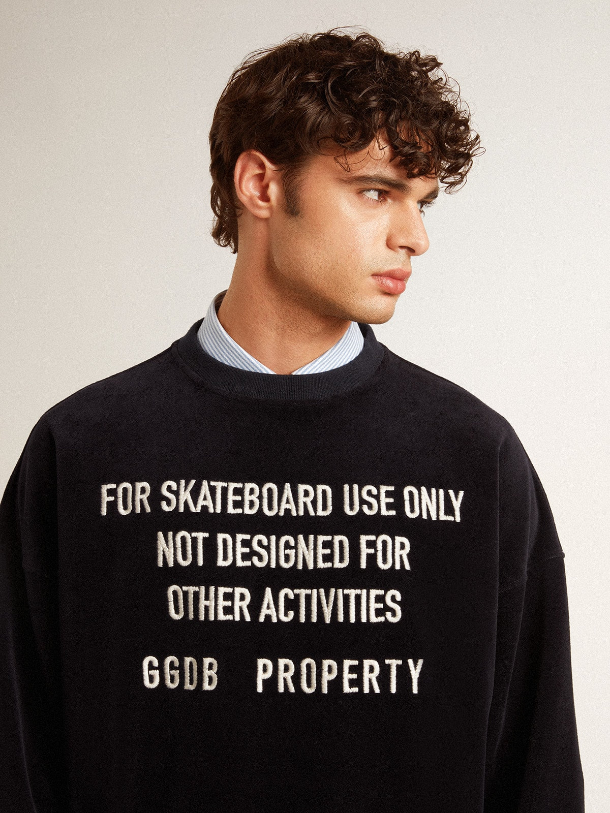 Black crew neck sweatshirt with embroidered lettering