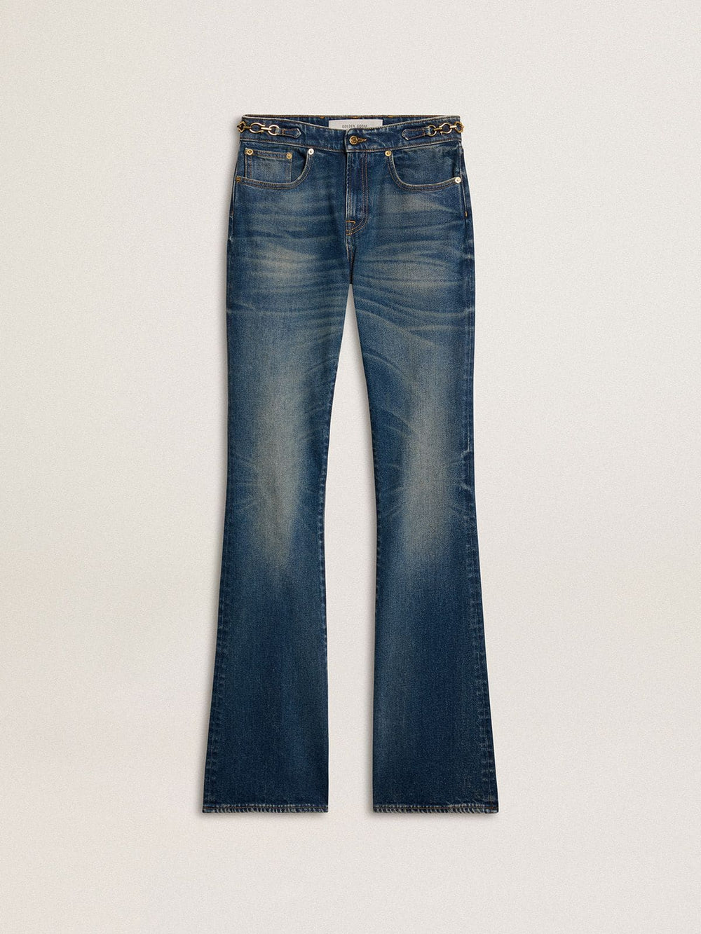 Women's bootcut jeans with a vintage wash and metallic details
