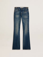 Women's bootcut jeans with a vintage wash and metallic details