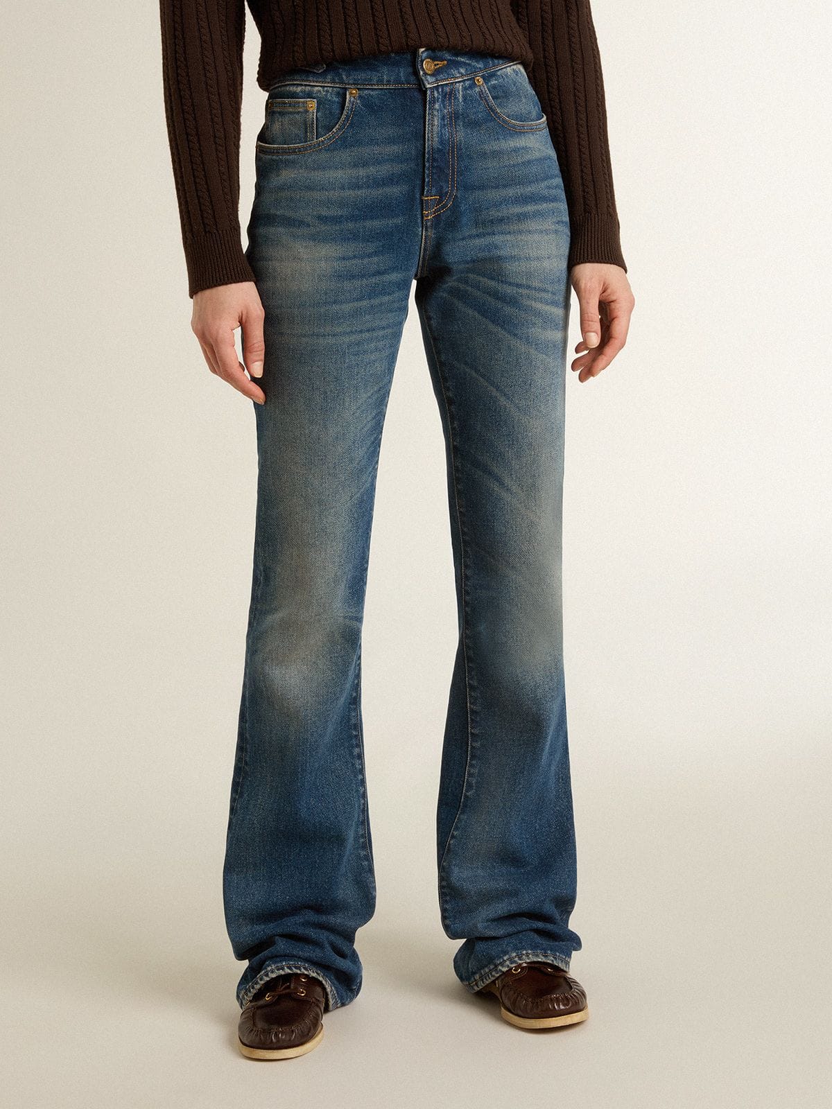 Women's bootcut jeans with a vintage wash and metallic details