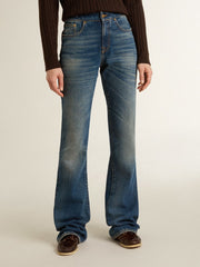 Women's bootcut jeans with a vintage wash and metallic details