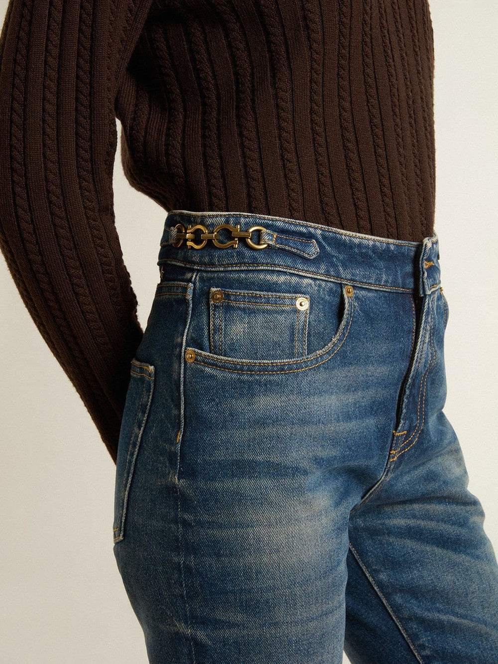 Women's bootcut jeans with a vintage wash and metallic details