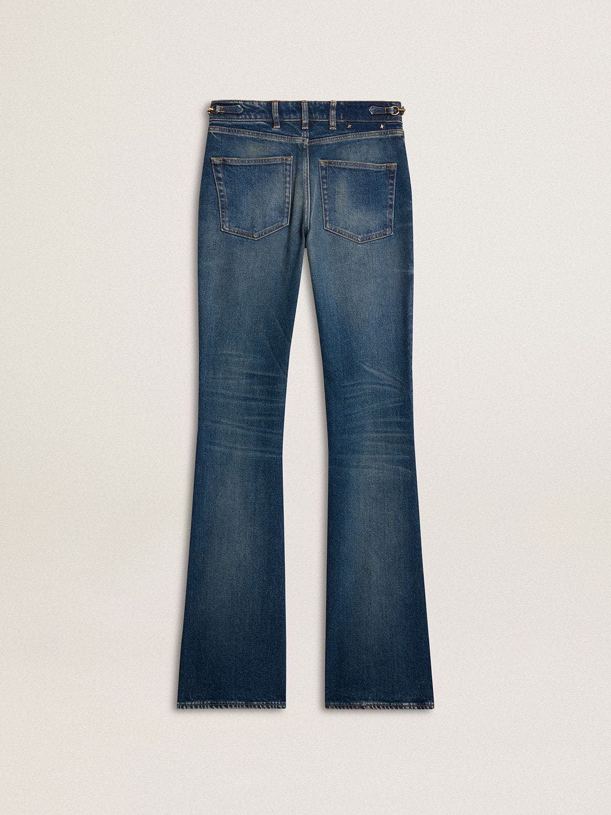 Women's bootcut jeans with a vintage wash and metallic details