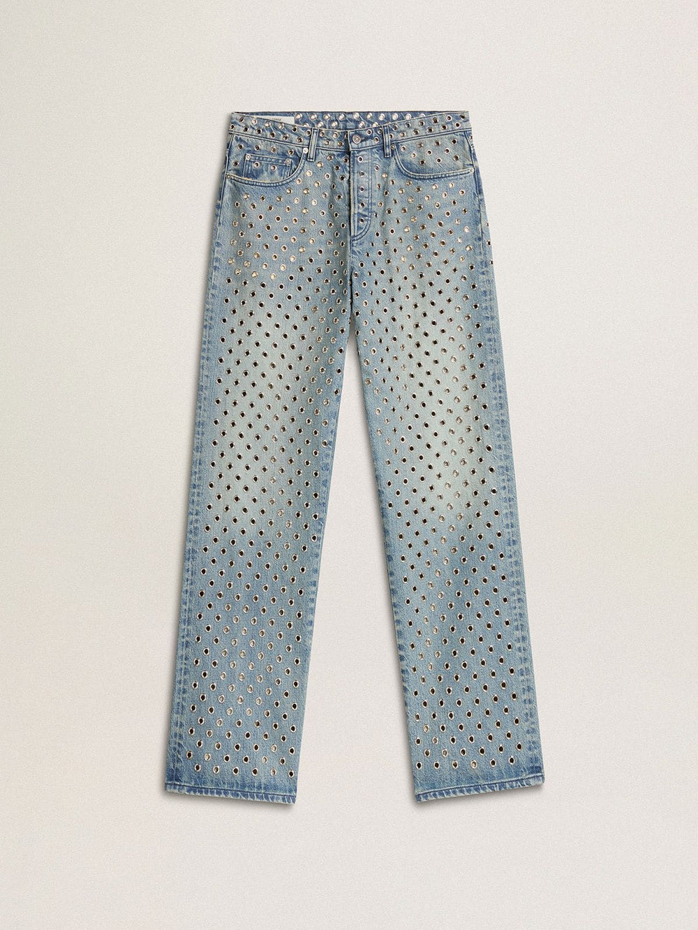 Women's washed jeans with all-over eyelets