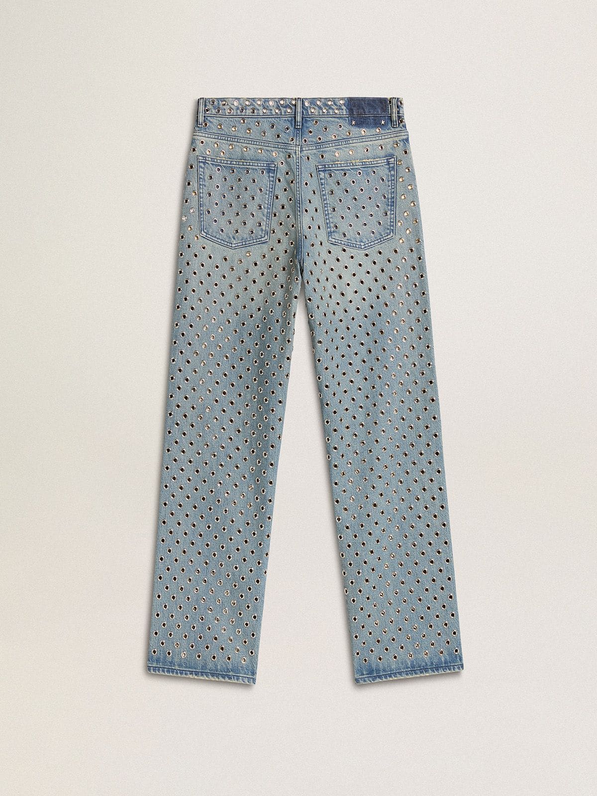 Women's washed jeans with all-over eyelets