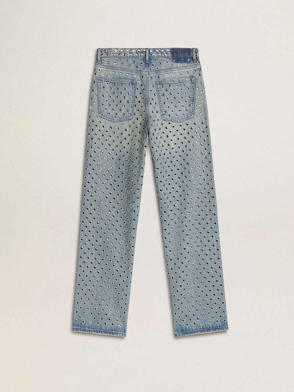 Women's washed jeans with all-over eyelets
