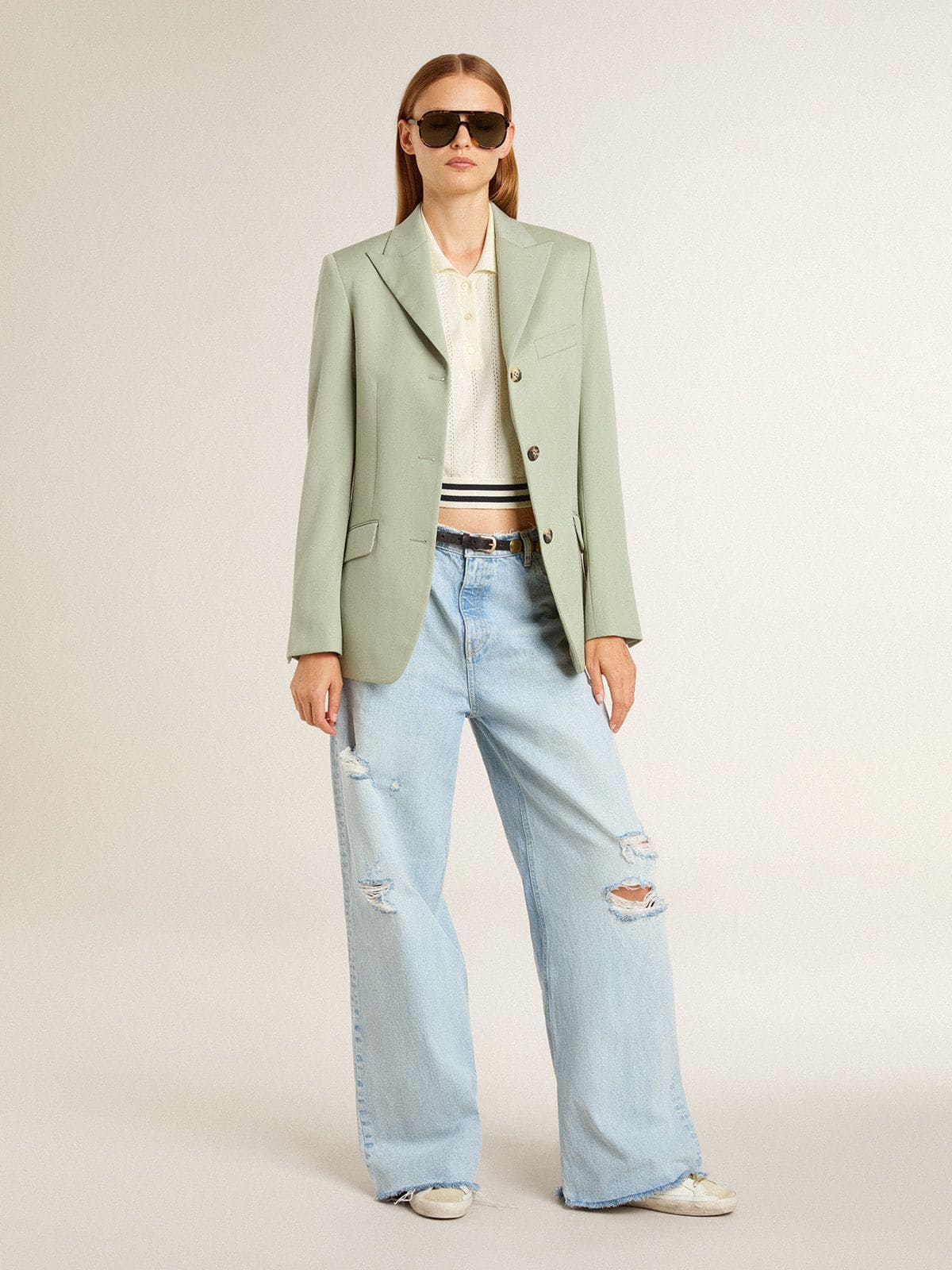 Women's cropped worn-white cotton polo shirt with blue ribbing