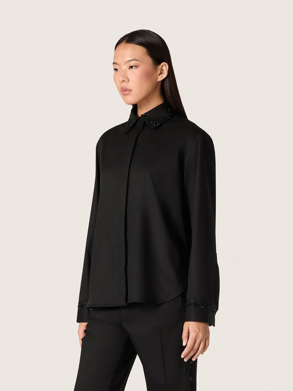 Women's shirt in black wool twill with floral embroidery in glass beads