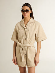Women's romper in beige denim with belt and frayed hem