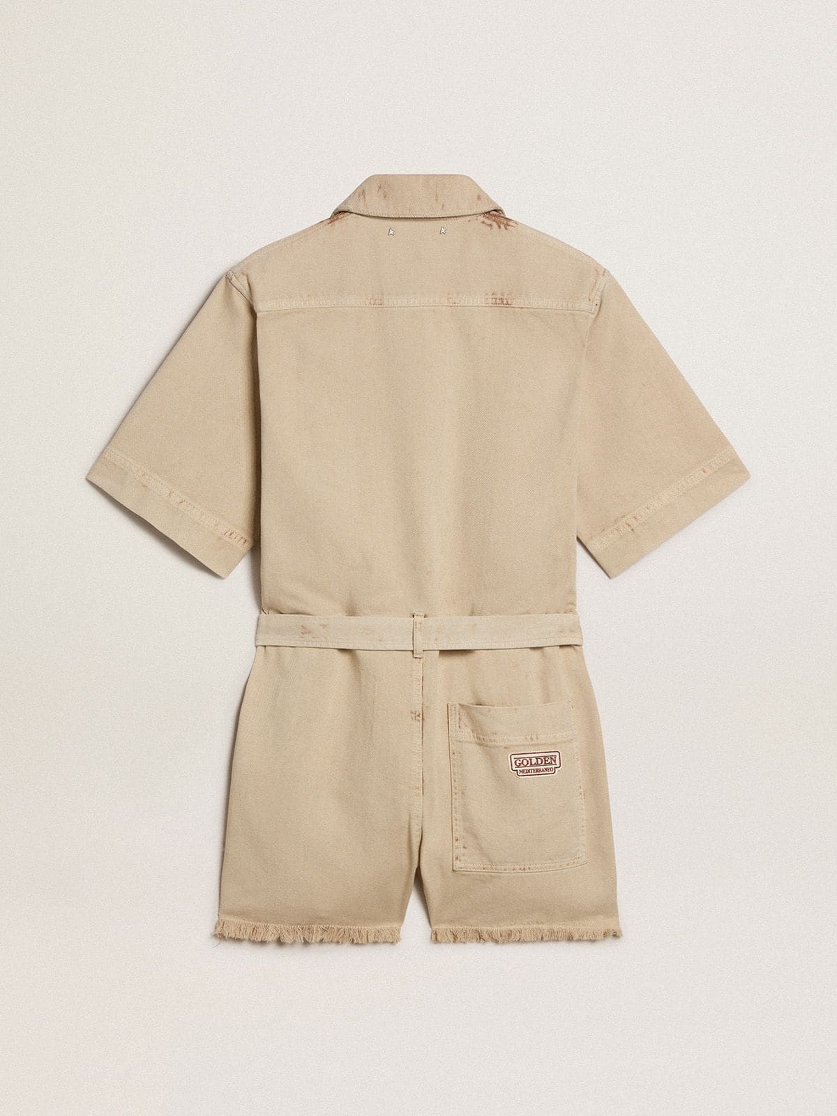 Women's romper in beige denim with belt and frayed hem